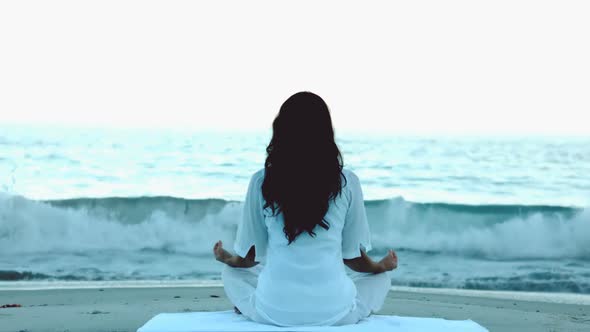 Woman Practicing Yoga In Front Of The Sea