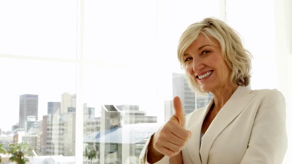 Happy Businesswoman Giving Thumbs Up