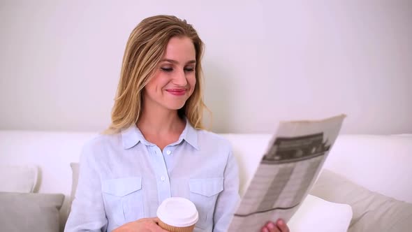 Woman Reading Newspaper And Drinking Coffee