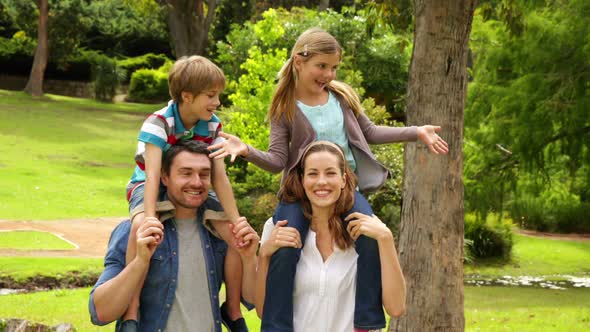 Happy Family Playing In The Park Together