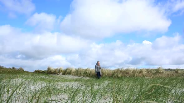 Woman Relaxing And Walking On The Beach