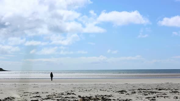 Woman Relaxing And Walking Toward The Sea