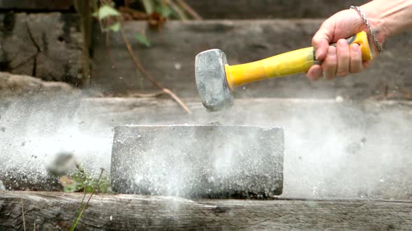 Sledge Hammer Smashing A Concrete Block