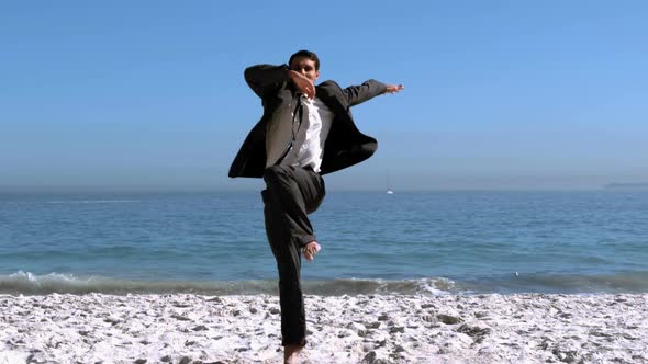 Businessman Jumping And Kicking On The Beach