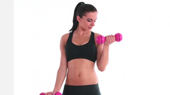Toned Smiling Brunette Working Out With Dumbbells