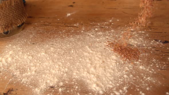 Flour And Bran Sprinkled Onto Wooden Work Surface