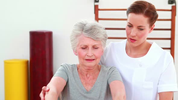 Physical Therapist Helping Patient Lift Hand Weights