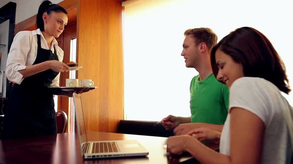 Couple Being Served Coffee In Canteen alt
