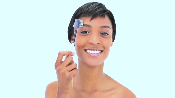 Beautiful Woman Brushing Her Eyebrow alt