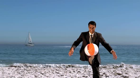 Businessman Playing On The Beach With A Balloon