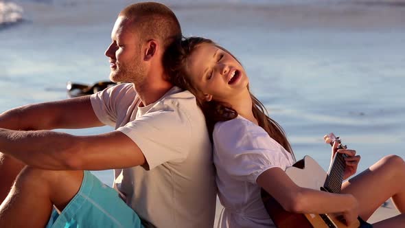 Couple Sitting On The Sand