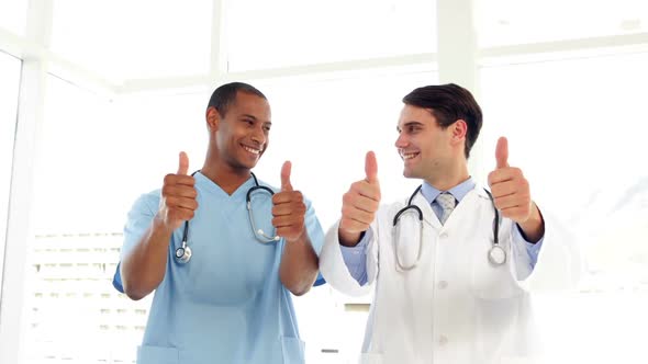 Happy Surgeon And Doctor Giving Thumbs Up