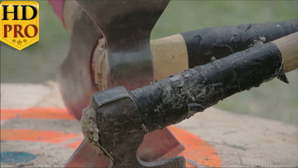 Three Axes Stuck on One Log Board