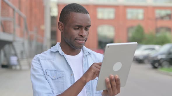 Portrait of African Man Using Tablet in Street