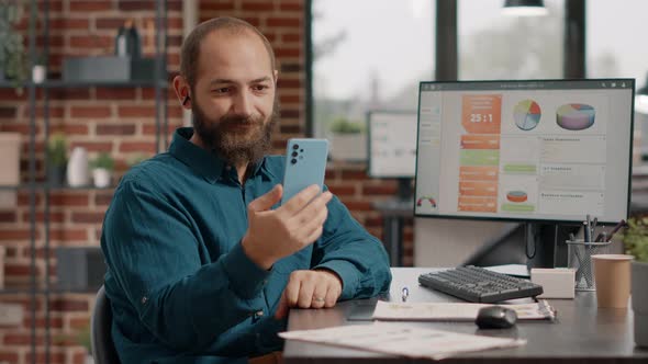 Employee Holding Smartphone to Talk on Video Call