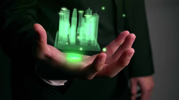 Businessman holds 3D city model showing augmented reality technology