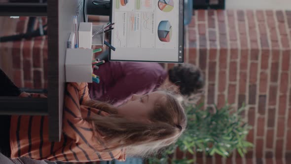 Vertical Video Working Mother Planning Project on Computer While Colleague Talking to Child