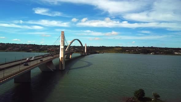 Beautiful drone shot flying next to the Juscelino Kubitschek Bridge in Brasilia on a sunny day