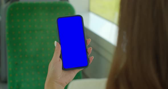 Close Up of a Woman Hand Holding a Mobile Telephone with a Vertical Blue Screen in Tram Chroma Key