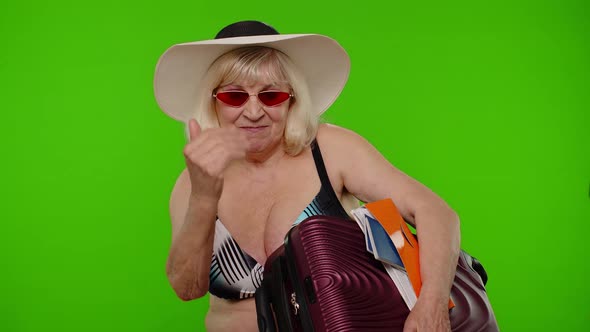 Senior Woman Tourist in Swimsuit with Luggage Passport Tickets Asking to Follow Join on Chroma Key