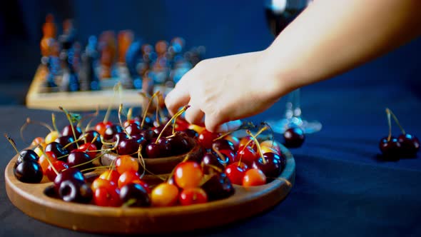 Close Up of Compartmental Dish with Different Varieties of Sweet Cherries on Table