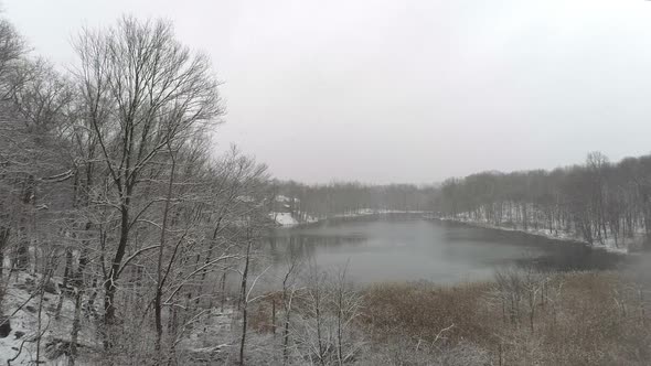 Lake Surrounded by Trees During a Snow Fall in Upstate New York