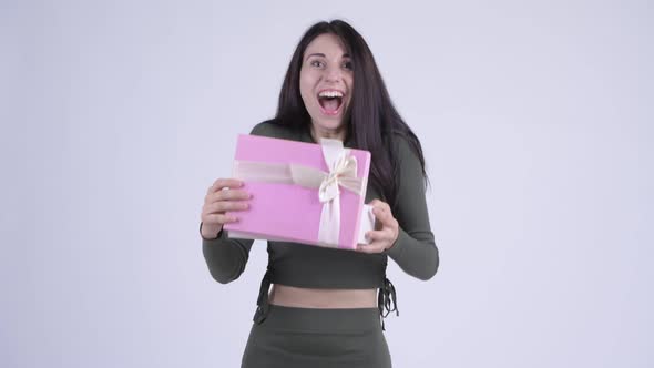 Happy Young Beautiful Woman Opening Gift Box and Looking Surprised