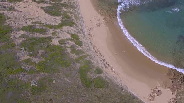 Aerial view above seagulls of cliff down to ocean at Point Nepean