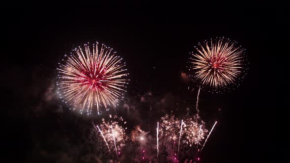 Big real fireworks display celebration and colorful New year's eve. An abstract blur of real golden