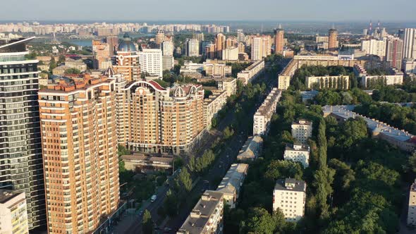 Aerial drone video of downtown apartment buildings and cars on the highway in Pecherskyi district of