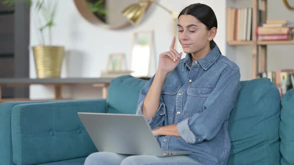 Latin Woman with Laptop Thinking at Work