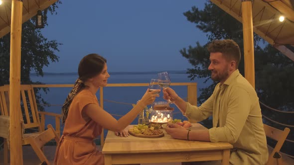 Couple Drinking Wine on Terrace by Lake