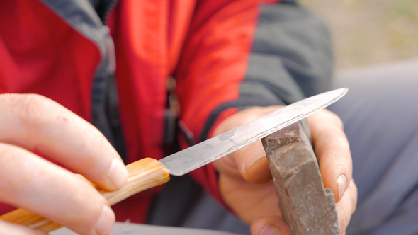 Camper Sharpening the Knife