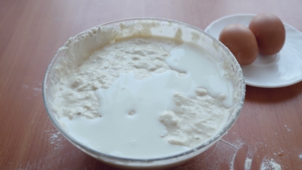 Milk Flowing Into The Dough And Hands Mixing Fresh alt
