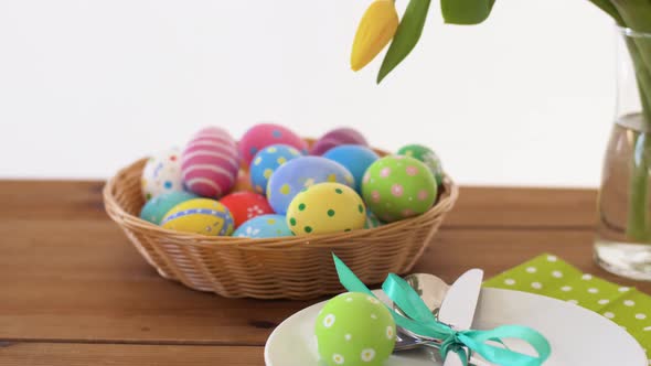 Easter Eggs in Basket and Flowers on Served Table