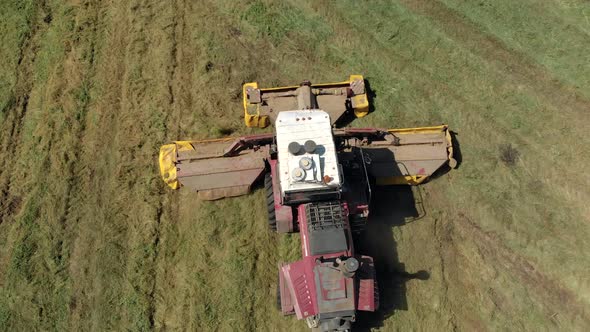 Aerial View of a Self Propelled Mower Cutting Juicy Green Grass on a Field in Hot Sunny Weather