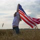 Happy Patriotic Young Woman Waves the US Flag and Jumps Into the Field - VideoHive Item for Sale