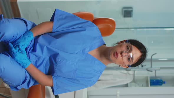 Vertical Video Dental Assistant Looking at Camera Speaking with Patients