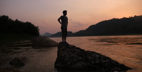 Asian Man Standing At River Side