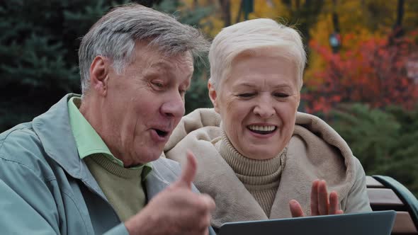 Positive Elderly Couple Making Video Call Using Laptop Older Generation People and Modern Wireless