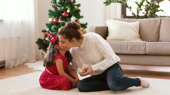 Mother and Daughter with Christmas Gift at Home 11