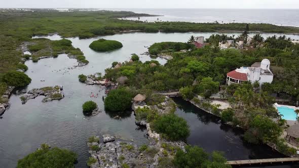 Panoramic view of beautiful sunset at tropical lagoon in Yal-Ku, Mexico. Top angel view of the river