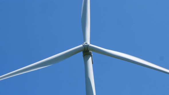 Electric windmill with long blades close-up. Wind turbine for the production of electricity.