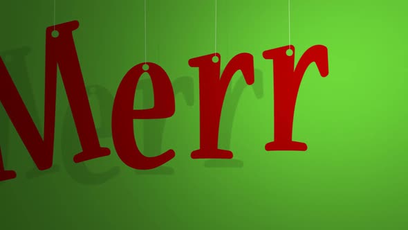 Red letters on a string creating a Merry Christmas word on the green background.