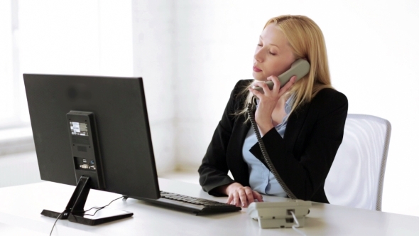 Businesswoman With Computer And Phone At Office