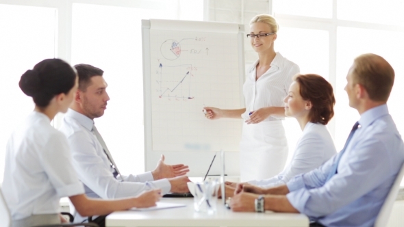 Business People With Flip Board Having Meeting