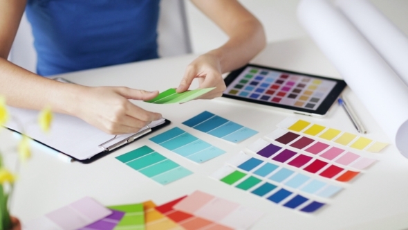 Woman Laying Out Color Palettes On Table