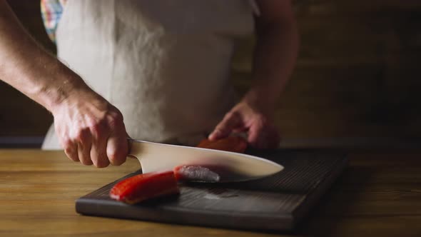 Chef in Apron Chops Delicatessen Cool Smoked Salmon Fillet