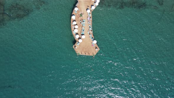 Umbrellas and Sun Loungers on the Pier on the Beach