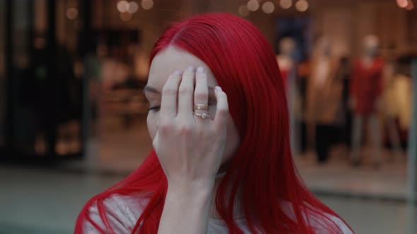 Beautiful Girl with Red Hair Looking at the Camera